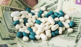 businessman with a pile of pills and dollar bills